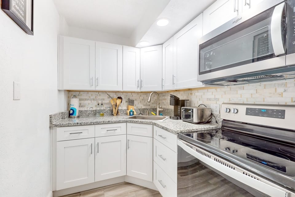 Fully equipped coastal kitchen with modern appliances, clean finishes, and ample counter space. Perfect for preparing meals and snacks during your relaxing beach stay near the ocean.
