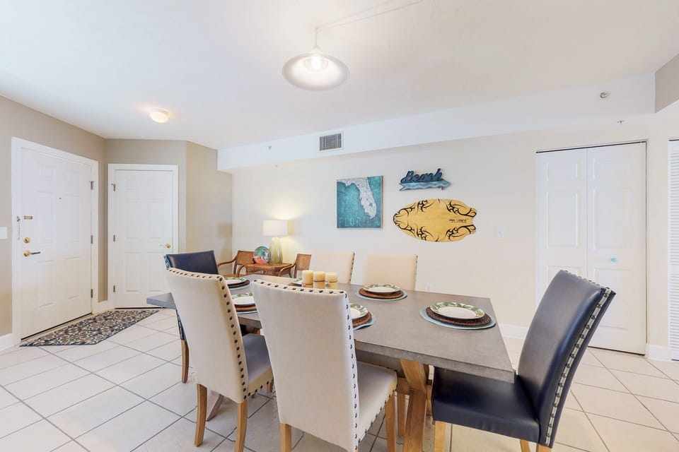 Enjoy meals together in this bright, beach-themed dining area with comfortable seating and coastal décor—perfect for family dinners during your relaxing beach stay.
