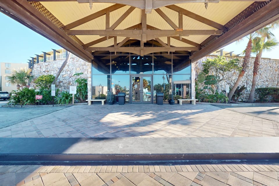 Arrive with ease to this inviting oceanfront resort entrance, setting the tone for a relaxing beach stay. Surrounded by tropical landscaping and coastal charm, it's the perfect start to your beachfront vacation experience.
