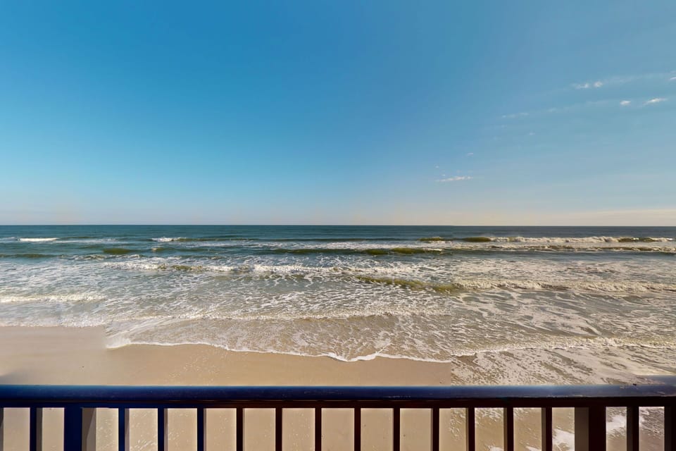 Take in endless oceanfront views during your beach stay with waves rolling onto sandy shores just steps away. This stunning seaside scene sets the perfect backdrop for sunrise coffee, sunset relaxation, and a truly memorable beachfront vacation.