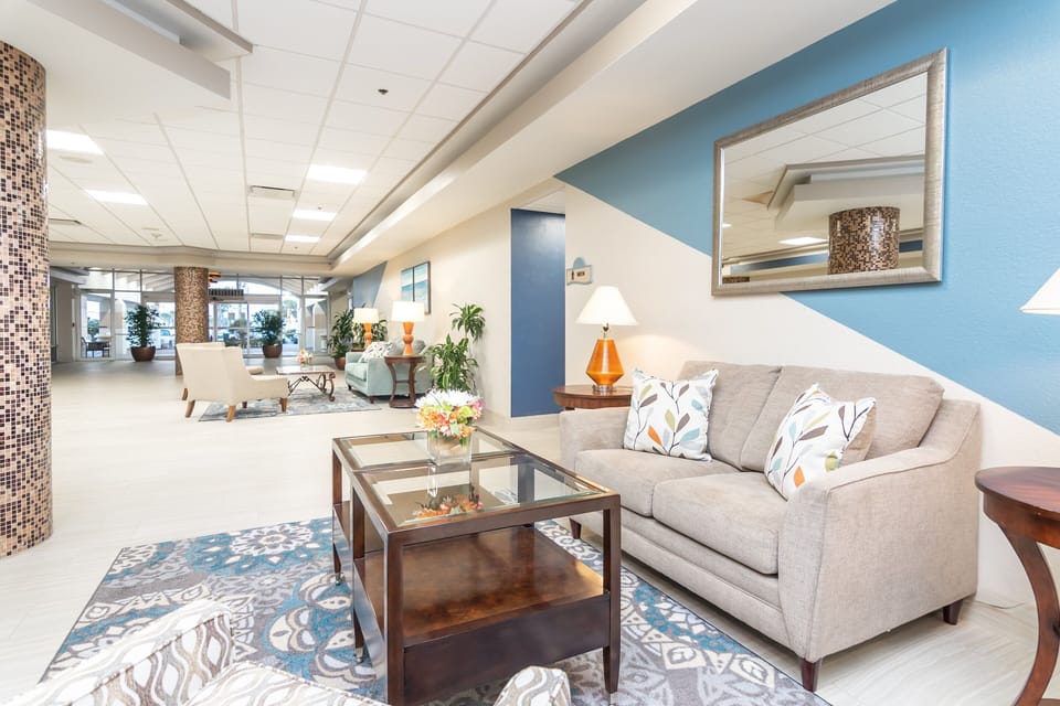 This bright beach stay lobby offers cozy seating, modern décor, and a welcoming atmosphere—perfect for relaxing before heading out to enjoy the shoreline.