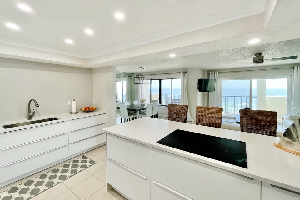 Enjoy coastal living in this modern beach stay featuring a spacious kitchen, island seating, and oceanview dining area—perfect for cooking, gathering, and relaxing after a day at the beach.