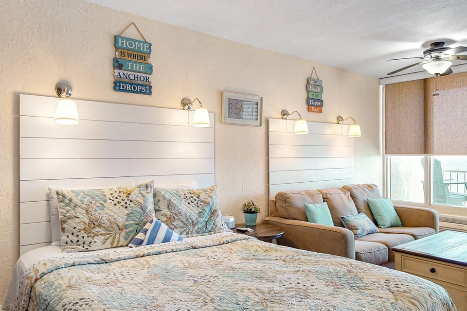 Bright beach-style studio featuring a comfortable bed, cozy sofa, and coastal décor. Perfect for a relaxing beach stay, offering comfort, ocean breezes, and a welcoming space to unwind after sandy days.