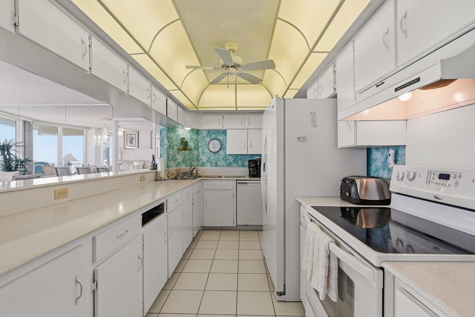 Prepare meals with ease in this bright, fully equipped kitchen, perfect for your beachfront vacation rental.