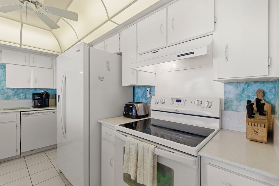 Prepare meals with ease in this fully equipped kitchen featuring bright coastal accents and modern appliances. Designed for comfort and convenience, it's perfect for fueling your beach stay before or after a day by the ocean.