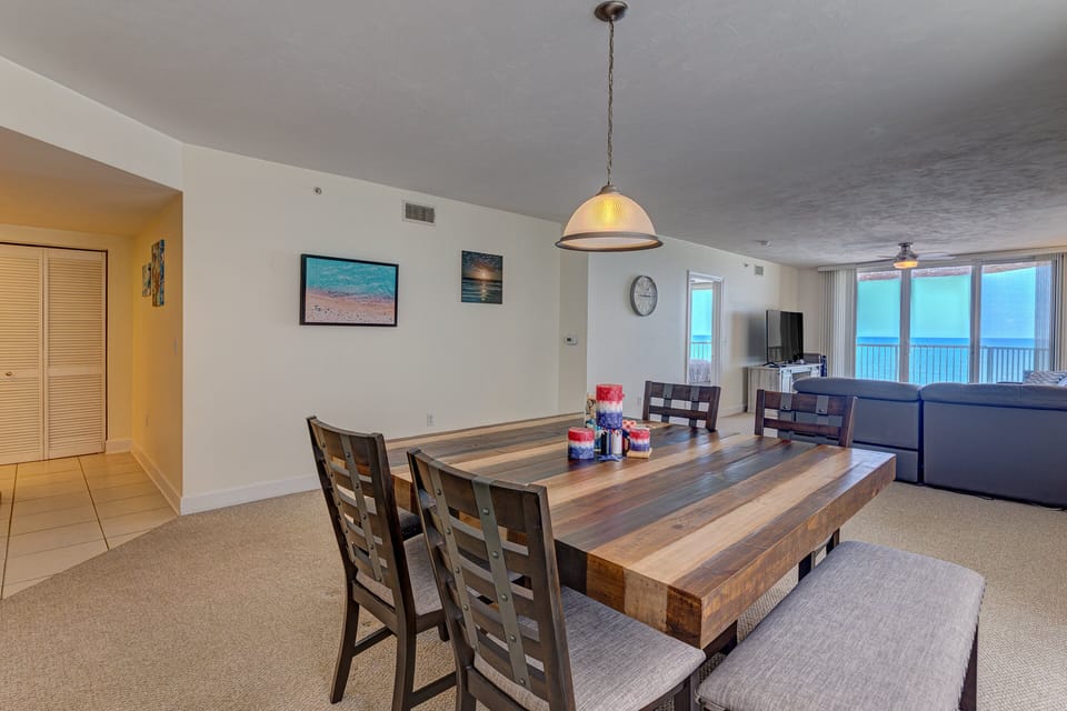 Open dining area with coastal décor and easy flow to the living room and balcony. Perfect for shared meals during beach stays, with ocean views setting the scene for relaxed coastal living.