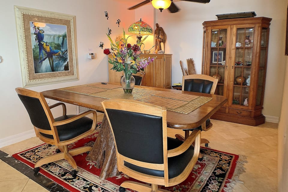 Gather for meals or games in this inviting dining area with warm décor and ample seating. Ideal for a laid-back beach stay, offering a cozy spot to connect and unwind after fun-filled days by the shore.