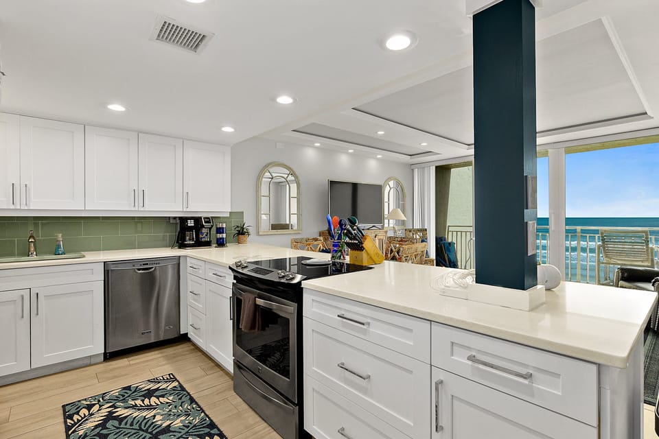 Enjoy a fully equipped oceanview kitchen with modern appliances, spacious counters, and coastal finishes. Cook with ease while soaking in beach views, just steps from the living area and private balcony—ideal for a relaxing beach stay.