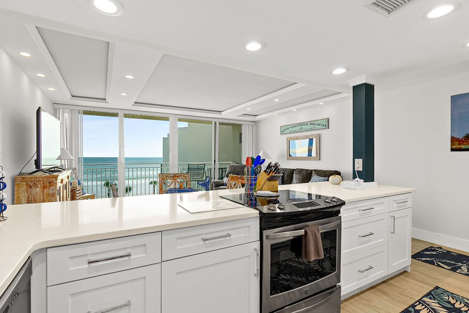 This open-concept kitchen flows seamlessly into the living area, showcasing modern finishes and stunning ocean views. Ideal for entertaining or unwinding after the beach, it's the perfect setting for a comfortable, scenic beach stay.