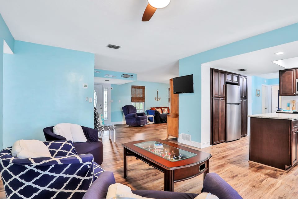 Gather and unwind during your beach stay in this open living area with comfortable seating, coastal décor, and easy flow to the kitchen—perfect for relaxing together after sunny days at the shore.