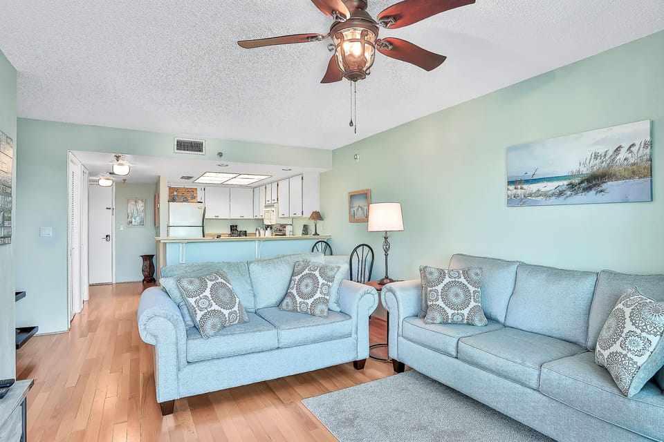 Enjoy this open and inviting coastal living space with plush seating and easy flow into the kitchen. Ideal for a relaxing beach stay, it's the perfect spot to gather, unwind, and recharge after seaside adventures.
