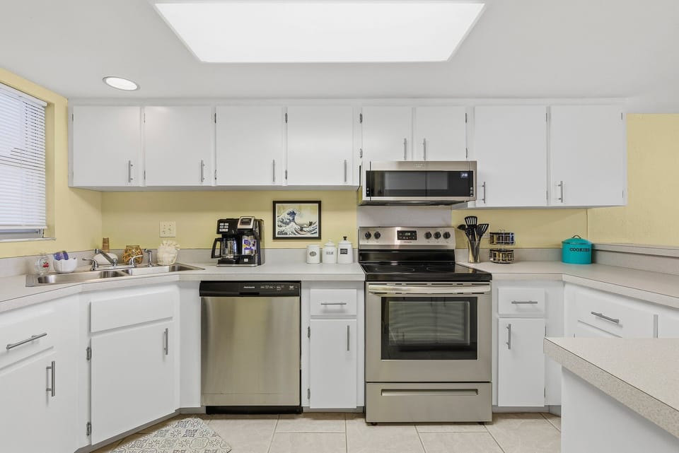 Clean, fully equipped kitchen with modern appliances, ample counter space, and coastal touches. Perfect for preparing meals during your beach stay and enjoying easy, comfortable living by the shore.