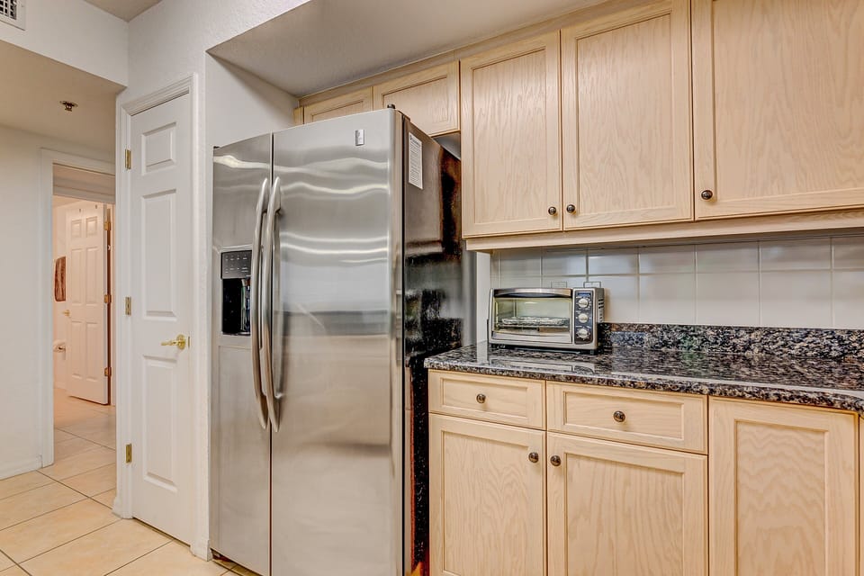 This well-equipped coastal kitchen offers stainless steel appliances, ample cabinet space, and modern conveniences. Ideal for your beach stay, it makes meal prep simple between sunny days by the ocean.