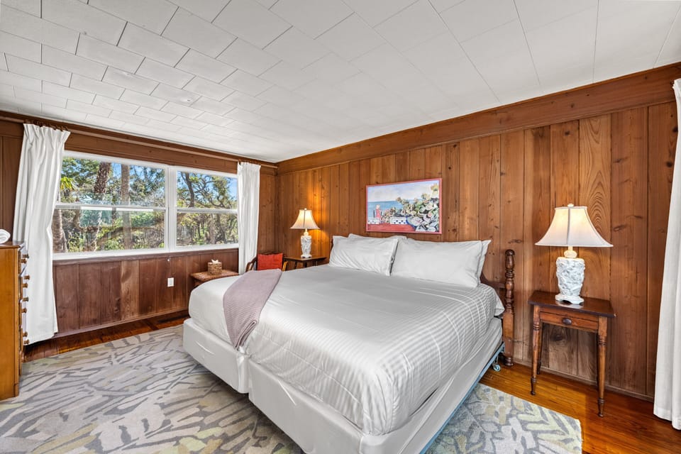 The second king bedroom offers a restful retreat, with soft linens, a desk bathed in natural light.