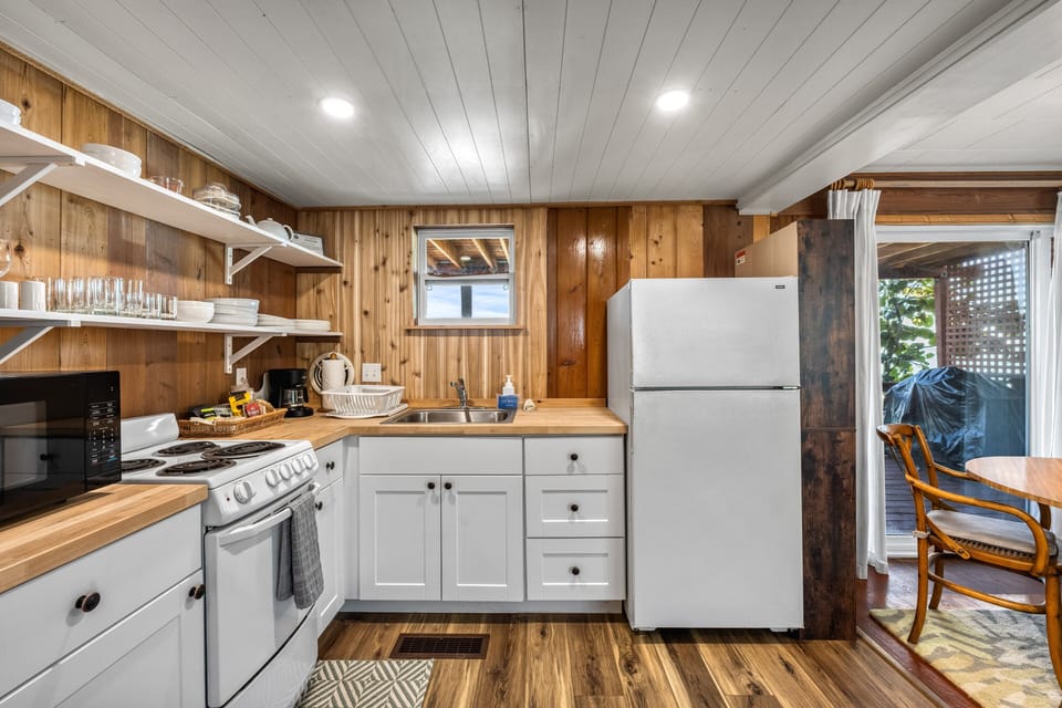The full kitchen with polished surfaces, ready for preparing family meals or snacks with views nearby.