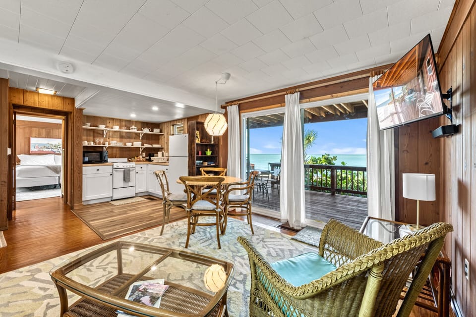 The living space feels spacious and inviting, with plush seating oriented toward windows framing serene Gulf vistas.