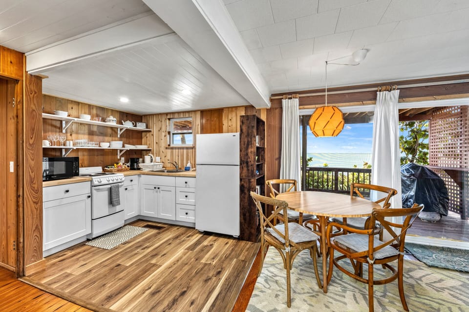The stove, oven, and countertops shine under natural light, ready for cooking and family meals.