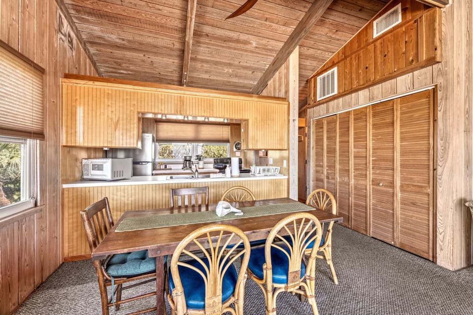 Bright, open kitchen and dining area with full-sized appliances, ample counter space, and a dining table ready for shared meals and gatherings.