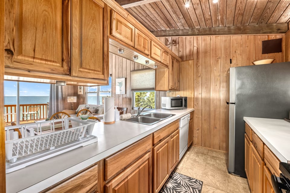 The full kitchen, bright and functional, lets you whip up island breakfasts or family dinners.