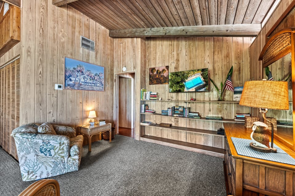 Wall-mounted TV anchors the living room, perfectly positioned for cozy viewing.