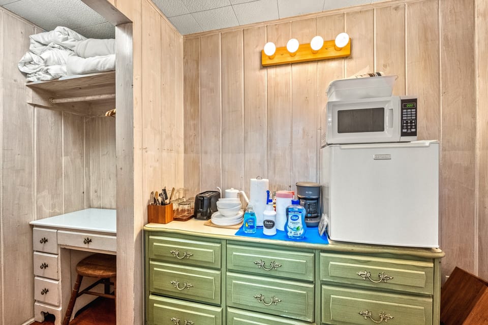 The compact kitchenette ready for a quick snack or a cup of coffee before heading outside.