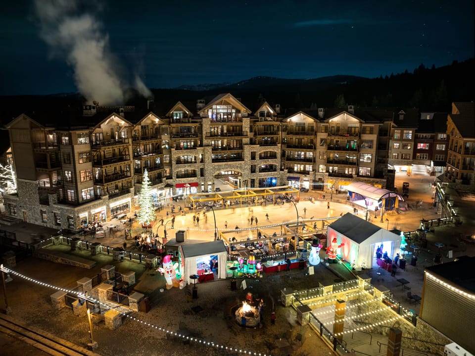 Experience the lively ambiance of this bustling mountain village at night, illuminated by twinkling lights and the energy of the resort.