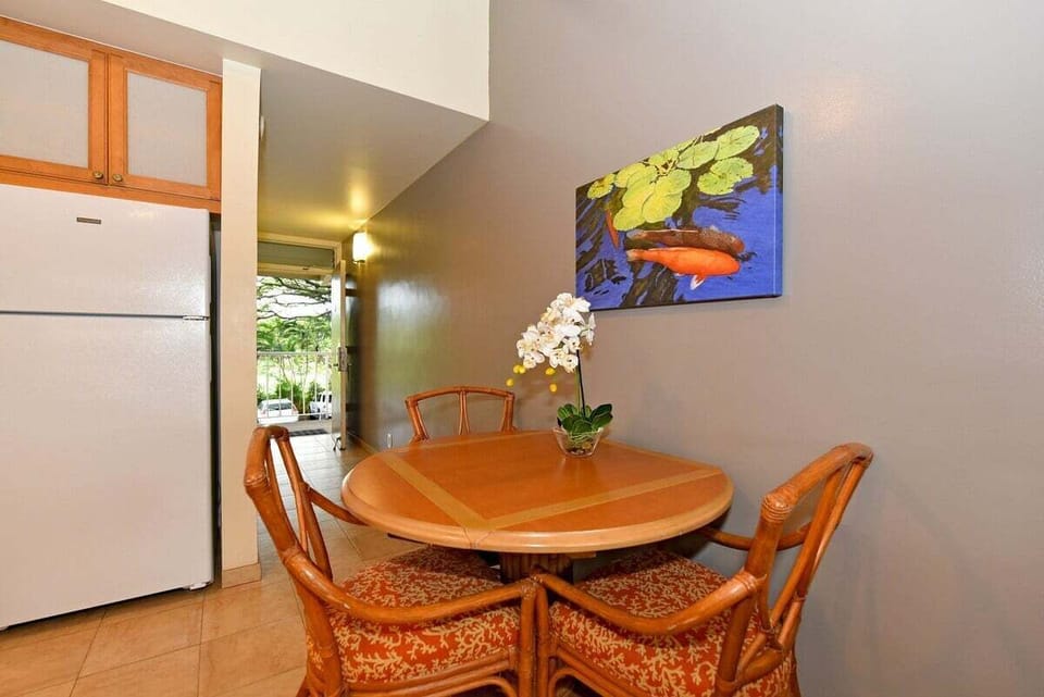 Gather around the four-seater table beside a compact kitchenette, complete with essentials and a splash of coastal color.