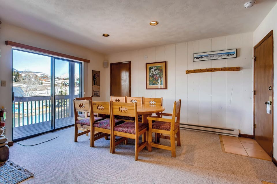 Gather around the rustic wooden dining table and enjoy the breathtaking mountain views just outside the large windows.