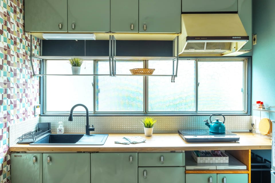 Retro kitchen with bold patterned tiles and modern sink for convenience.