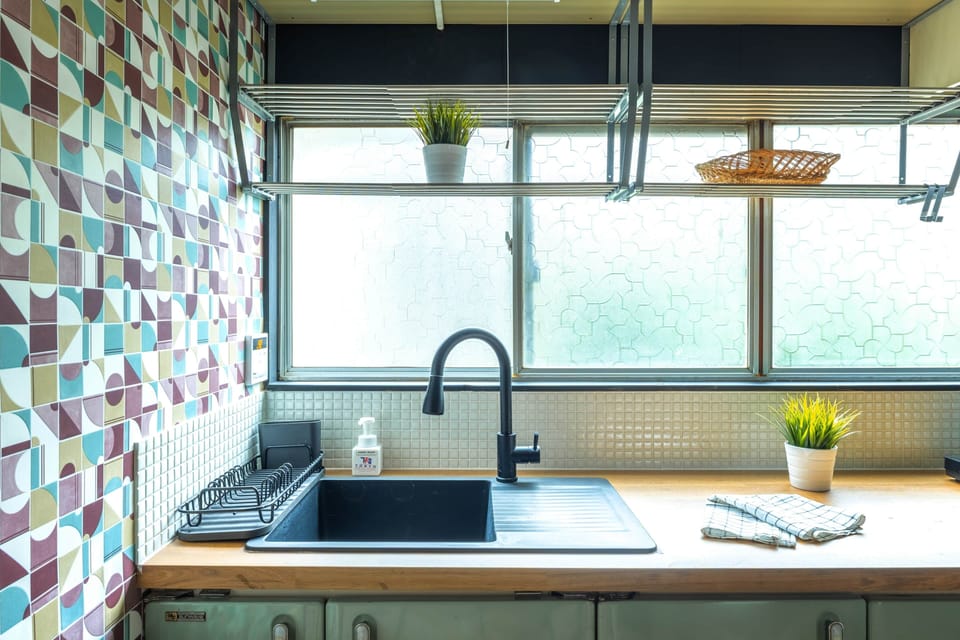 A retro kitchen with colourful cupboards and modern conveniences.