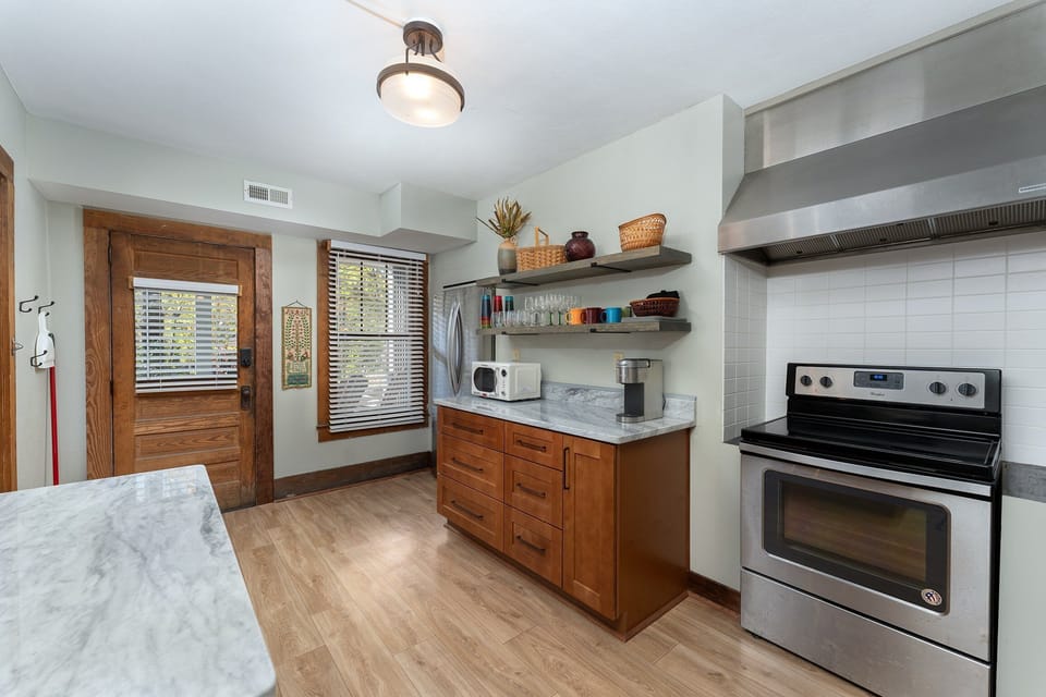 Fully equipped kitchen with gas range, dishwasher, and Keurig coffee maker