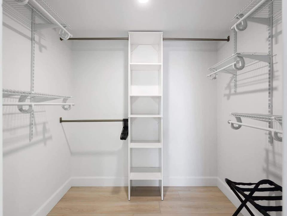 Primary bathroom with double vanities, large walk-in shower, large walk-in closet, and en-suite bedroom.