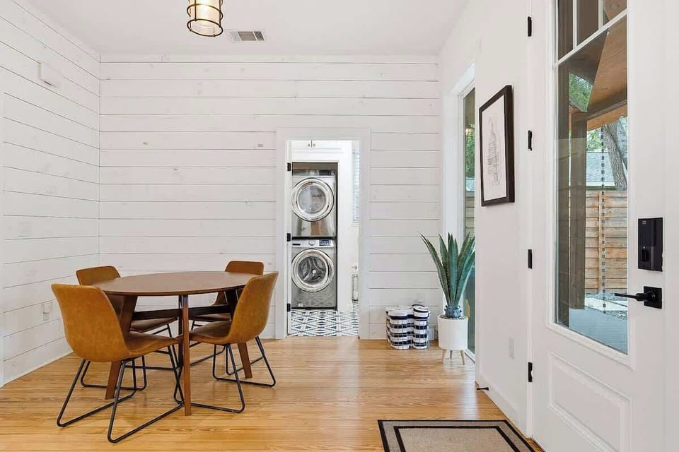 A small breakfast nook is just off of the kitchen and leads to a half guest bathroom / laundry room.