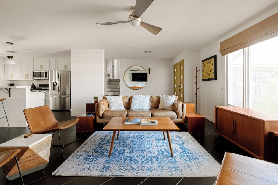 Mid-Century Modern Living Room with Multiple Seating Options and TV