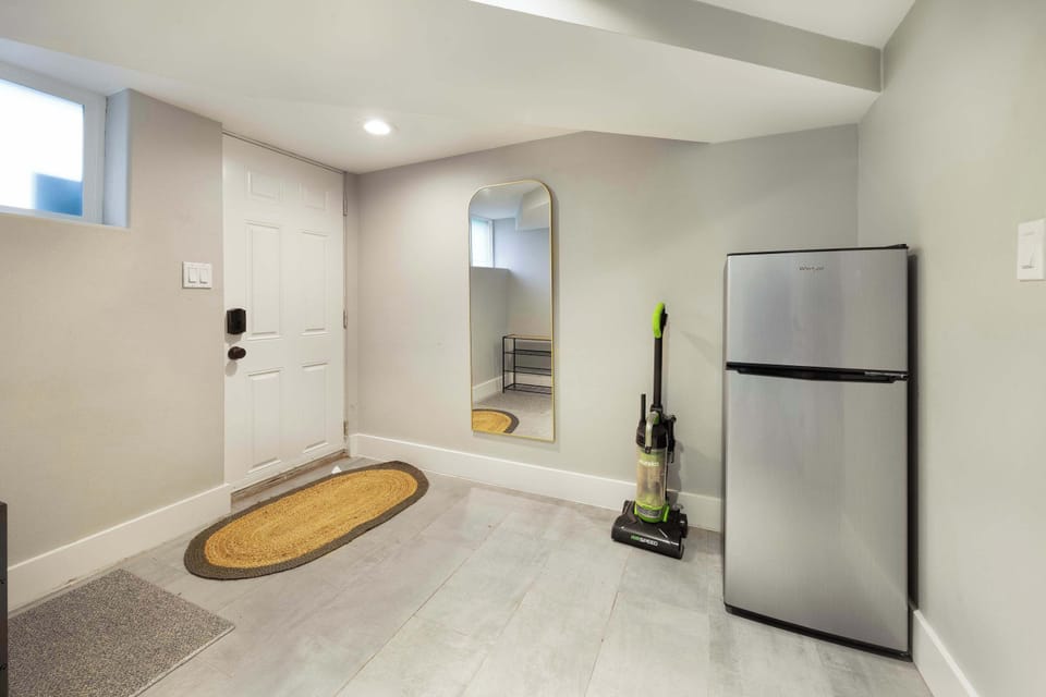 Convenient mudroom space with a full-size fridge for extra storage.