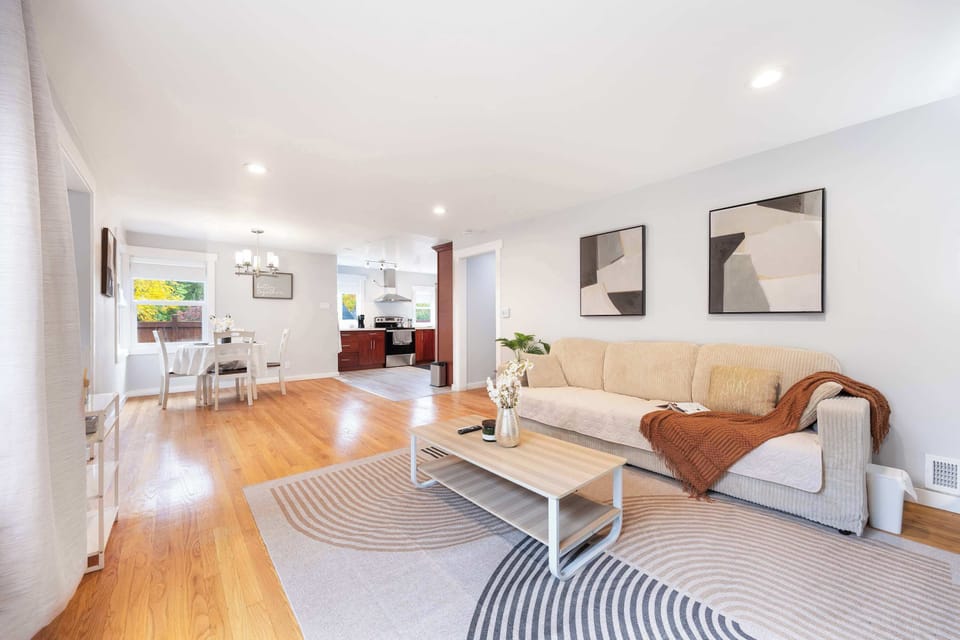 Open-concept living space glowing with natural light, connecting seamlessly to the dining and kitchen areas.