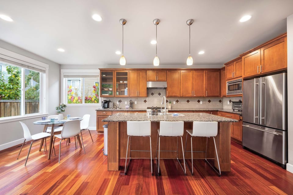 Fully equipped kitchen with stainless steel appliances and room for everyone to gather.