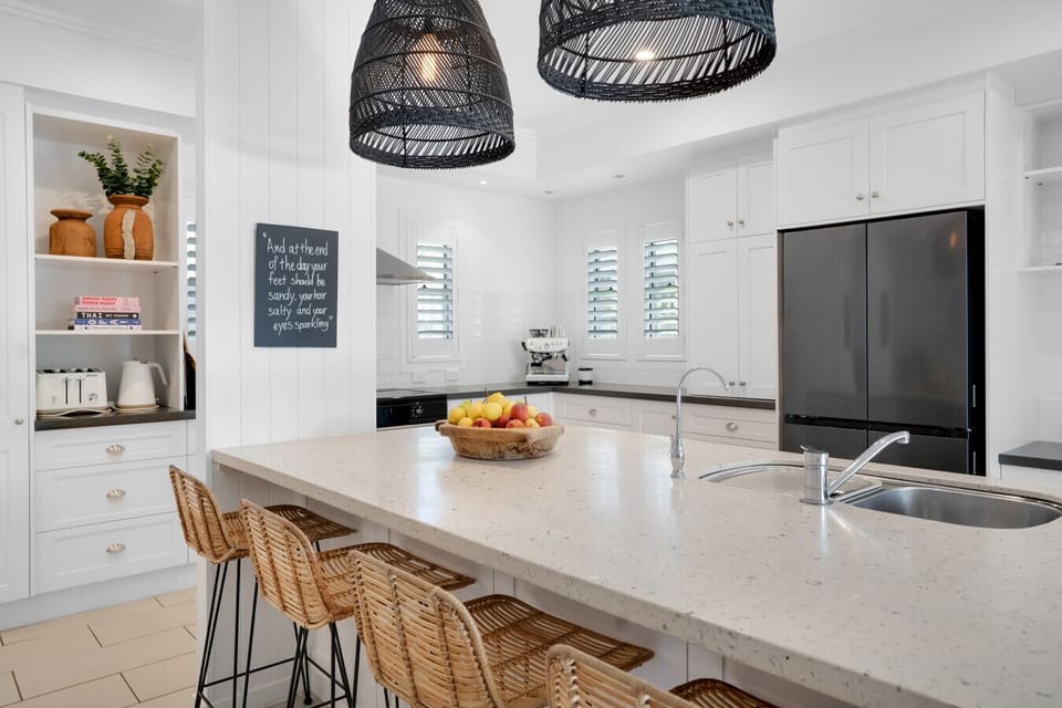 Fully equipped kitchen with island bench and espresso coffee machine