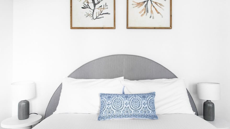 Bedroom with framed artwork and cozy ambiance.
