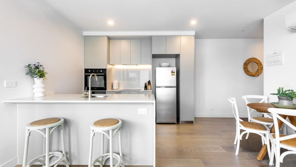 Sleek kitchen island with bar stools, perfect for casual dining.
