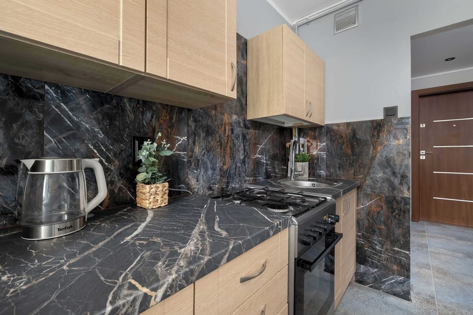 The modern countertops and light cabinetry create a functional setup where staying organized and cooking favourite meals feels effortless.