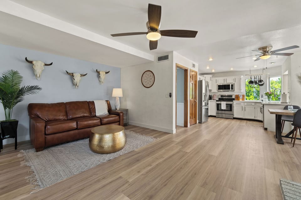Stylish open living room flowing directly into the updated kitchen.
