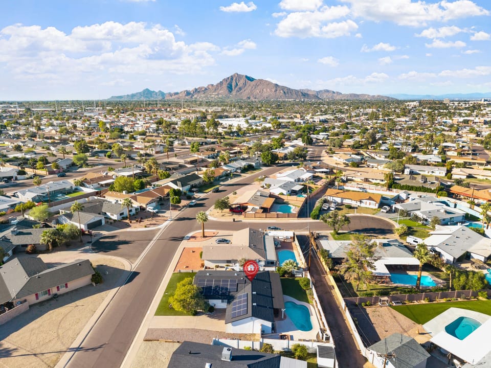 Aerial view of the neighborhood with a prominent mountain in the background.
