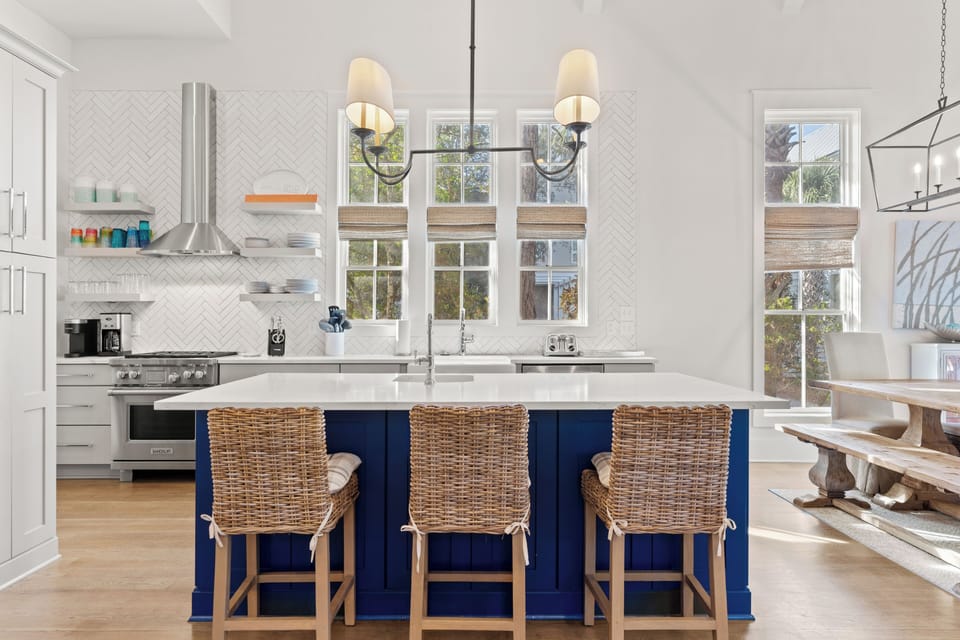 Kitchen features a barstool seating and modern appliances.