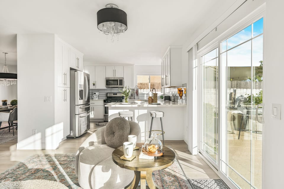 Casual seating area near the kitchen, featuring a small round table and window views.