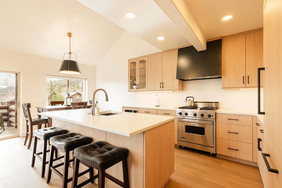 Inviting kitchen and dining space with bar seating and natural light.