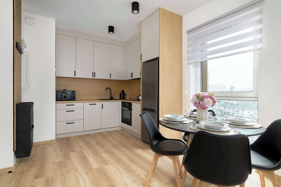 Another perspective of the kitchen-dining area, emphasizing its open layout and bright atmosphere.