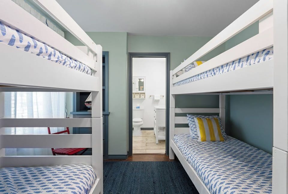 Sleep soundly in these cheerful bunk beds with soft blue linens and colorful accents. Perfect for family adventures.