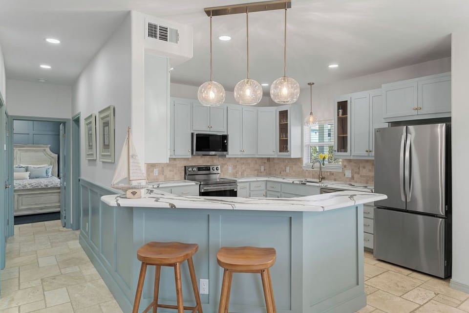 Your spacious kitchen welcomes you with elegant pendant lighting, marble countertops, and modern appliances for effortless cooking and entertaining.