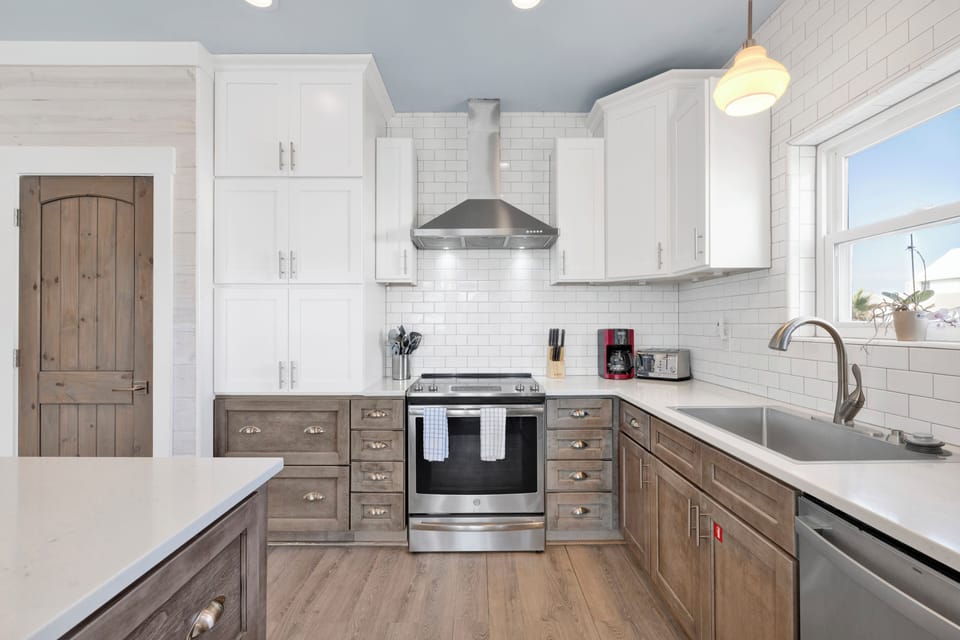 The fully equipped kitchen offers stainless appliances and stone counters